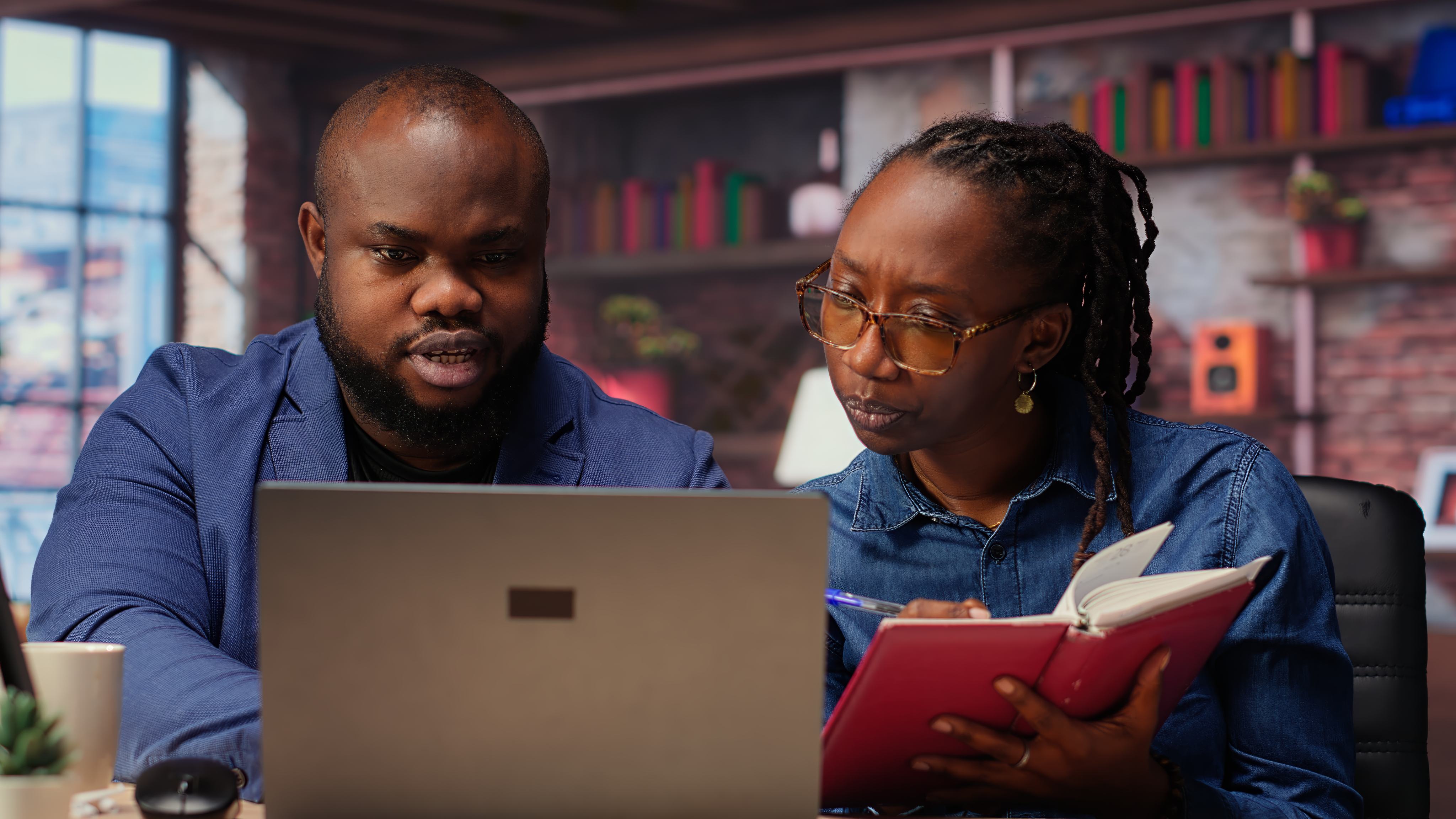 Team reviewing work on a laptop